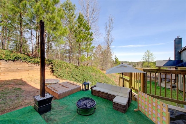view of patio / terrace with an outdoor fire pit and fence