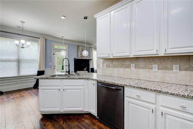kitchen featuring dishwasher, a sink, a peninsula, dark wood finished floors, and wainscoting