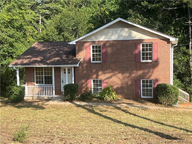 view of front of house featuring a front yard and covered porch