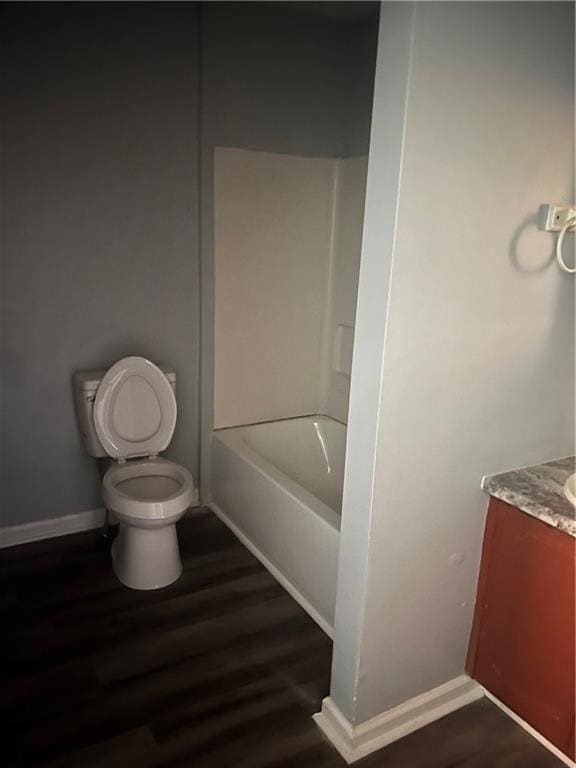 full bathroom featuring vanity, toilet, hardwood / wood-style flooring, and shower / bath combination