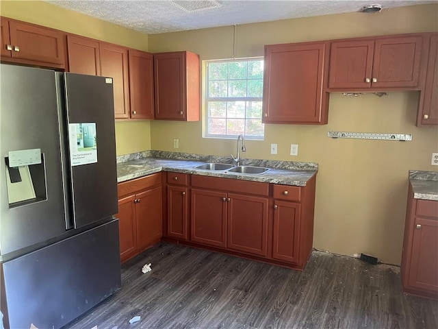 kitchen featuring dark hardwood / wood-style floors, sink, a textured ceiling, and stainless steel refrigerator with ice dispenser