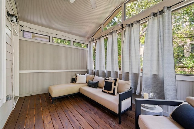 sunroom with ceiling fan and vaulted ceiling