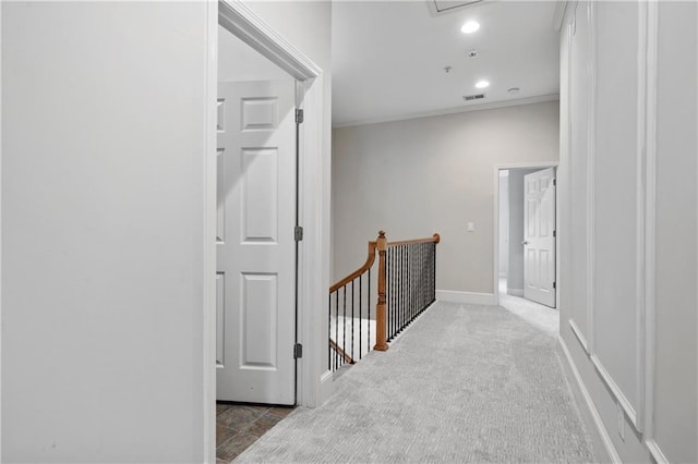 hall featuring light carpet and ornamental molding