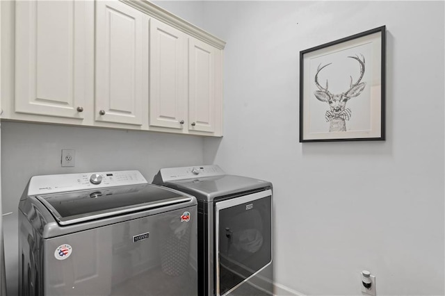 washroom featuring cabinets and separate washer and dryer