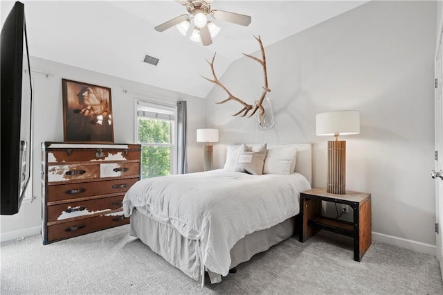 carpeted bedroom with vaulted ceiling and ceiling fan