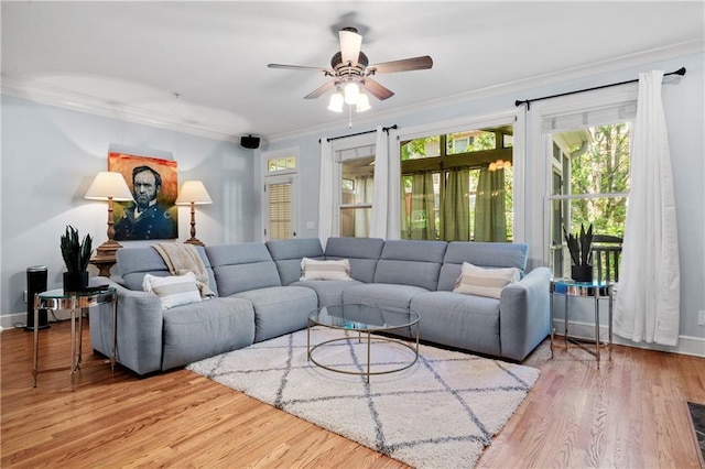 living room featuring ceiling fan, light hardwood / wood-style flooring, and ornamental molding