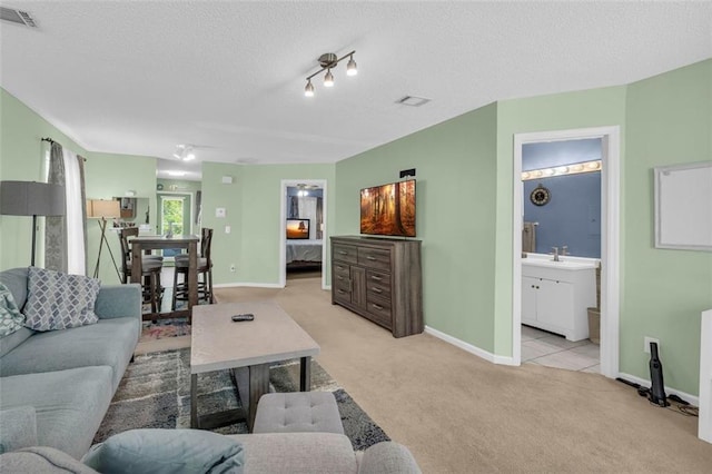 6178 Field Stone Dr, Douglasville, GA 30134 - living room featuring light carpet and a textured ceiling
