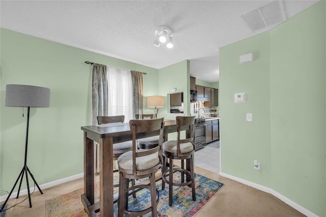 6178 Field Stone Dr, Douglasville, GA 30134 - dining room featuring light colored carpet and a textured ceiling