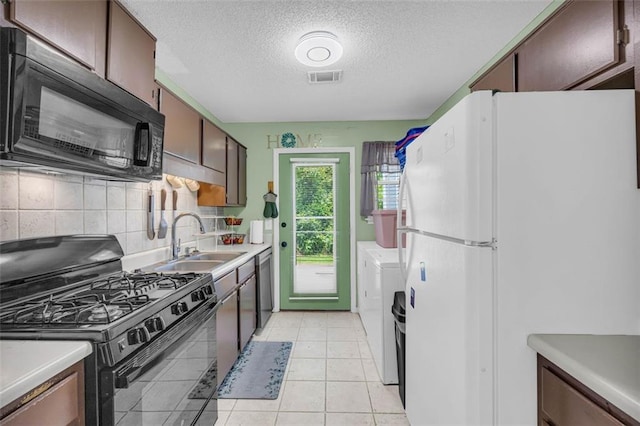 6178 Field Stone Dr, Douglasville, GA 30134 - kitchen featuring black appliances, a textured ceiling, tasteful backsplash, light countertops, and light tile patterned flooring