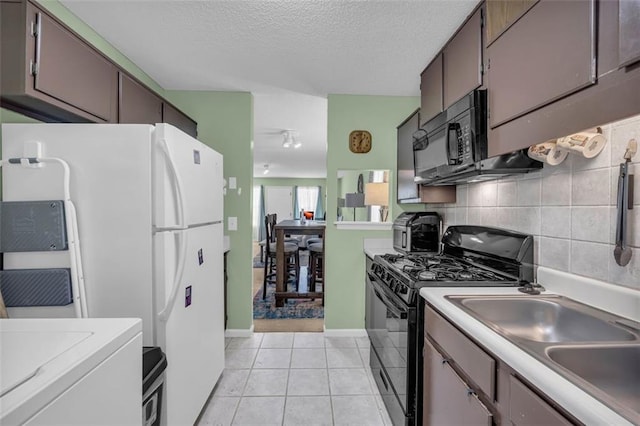 6178 Field Stone Dr, Douglasville, GA 30134 - kitchen with black appliances, tasteful backsplash, light countertops, light tile patterned flooring, and a textured ceiling