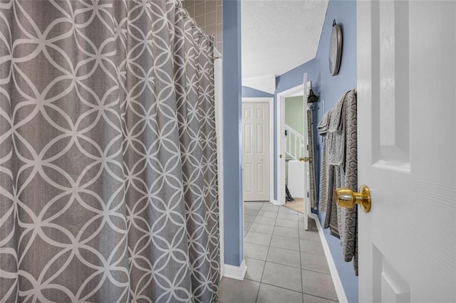 6178 Field Stone Dr, Douglasville, GA 30134 - full bathroom featuring a textured ceiling, tile patterned floors, and a shower with shower curtain