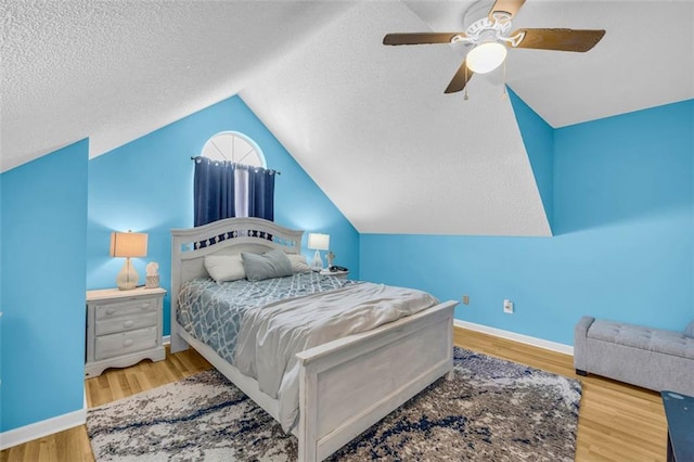 6178 Field Stone Dr, Douglasville, GA 30134 - bedroom with vaulted ceiling, wood finished floors, a ceiling fan, and a textured ceiling