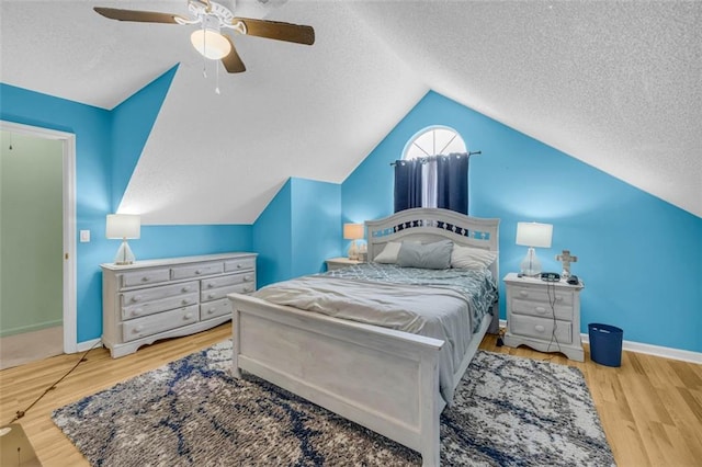 6178 Field Stone Dr, Douglasville, GA 30134 - bedroom featuring a textured ceiling, vaulted ceiling, a ceiling fan, and wood finished floors