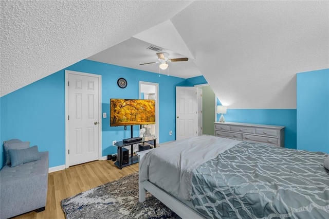 6178 Field Stone Dr, Douglasville, GA 30134 - bedroom featuring a textured ceiling, wood finished floors, a ceiling fan, and lofted ceiling
