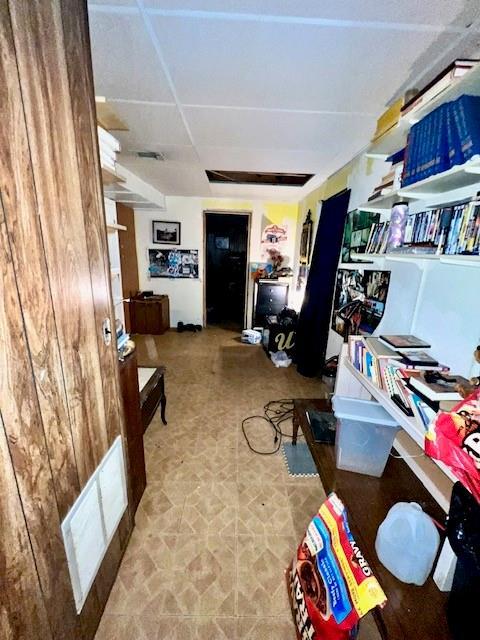 living area featuring visible vents and a paneled ceiling