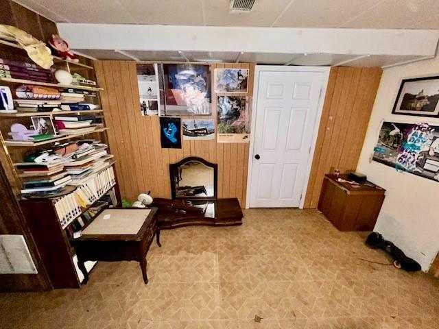 living area with tile patterned floors and visible vents
