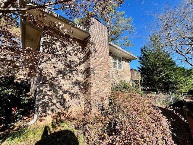 view of side of home with brick siding