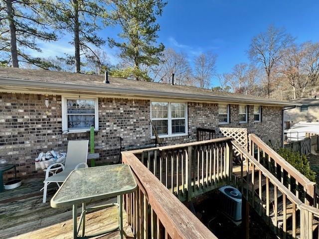 deck featuring outdoor dining area and cooling unit