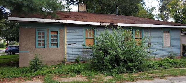 view of side of home with a chimney