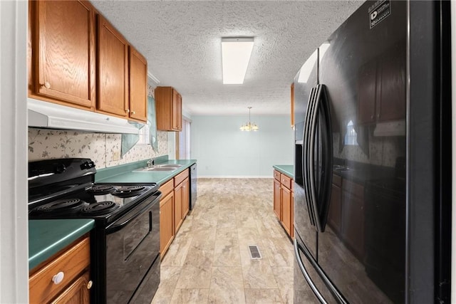 kitchen featuring sink, black appliances, a textured ceiling, decorative light fixtures, and a chandelier