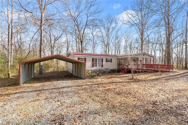 view of front of home with a carport and a deck