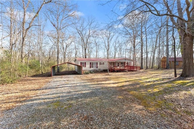 view of front of home with a carport and a deck