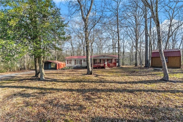 view of yard featuring a porch and a shed