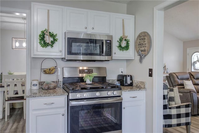 10 Alexandria Ln, Dallas, GA 30132 - kitchen with appliances with stainless steel finishes, light wood-style flooring, white cabinets, and lofted ceiling