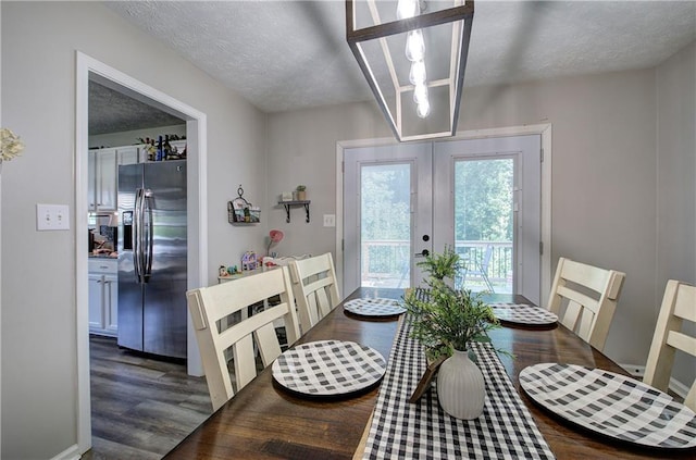 10 Alexandria Ln, Dallas, GA 30132 - dining space with french doors, wood finished floors, and a textured ceiling