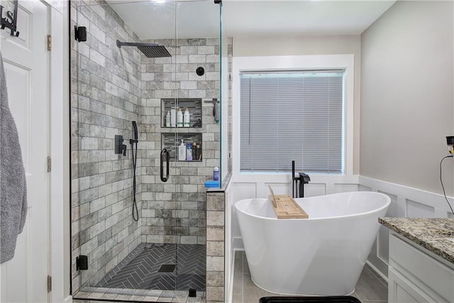 10 Alexandria Ln, Dallas, GA 30132 - full bathroom with a soaking tub, a stall shower, vanity, a wainscoted wall, and a decorative wall