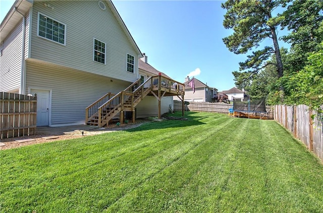 10 Alexandria Ln, Dallas, GA 30132 - back of house featuring a trampoline, stairs, a fenced backyard, and a wooden deck