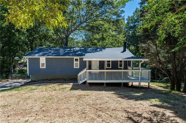 view of front of house featuring a front yard and a deck