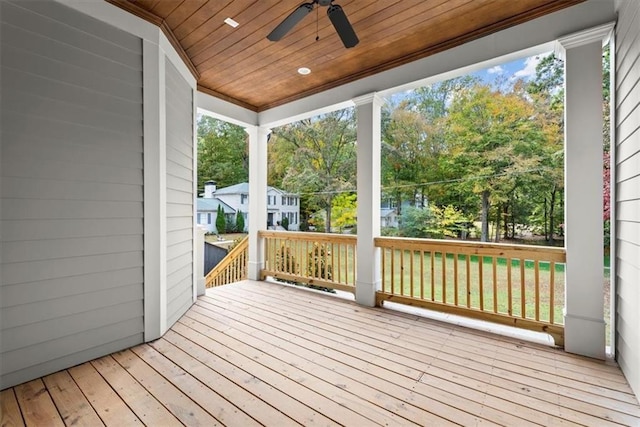 deck featuring ceiling fan and a yard