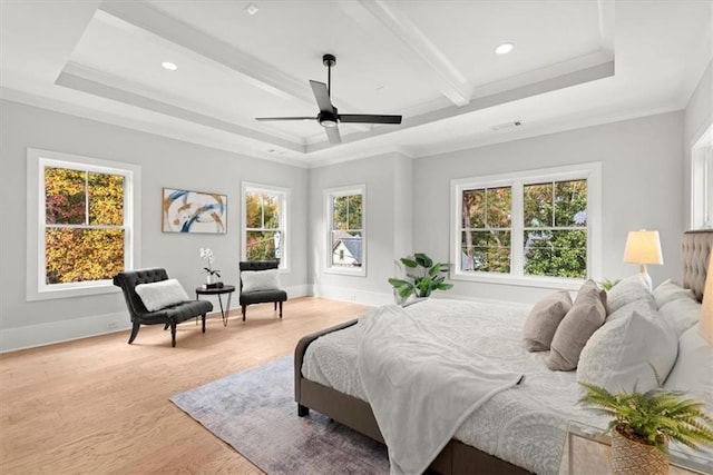 bedroom with beamed ceiling, multiple windows, ceiling fan, and light hardwood / wood-style flooring