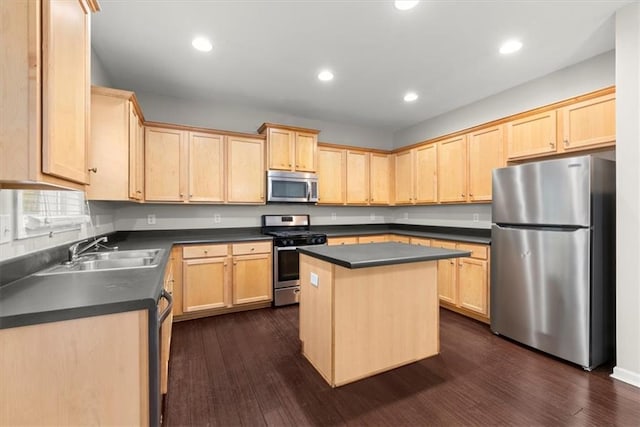 kitchen featuring dark hardwood / wood-style flooring, appliances with stainless steel finishes, a kitchen island, light brown cabinetry, and sink