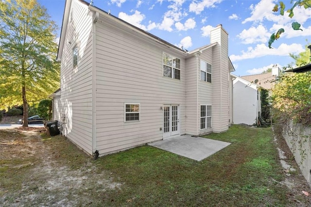 rear view of house featuring a patio and a lawn