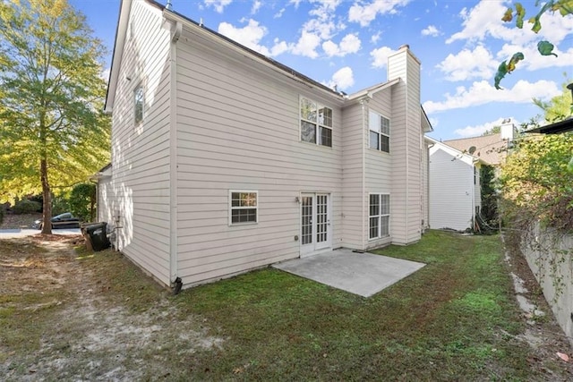 911 Queensbrooke Way, Mableton, GA 30126 - back of house featuring a chimney, a patio area, a yard, and french doors