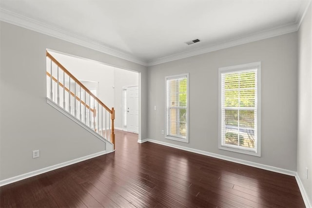 empty room with ornamental molding and dark wood-type flooring