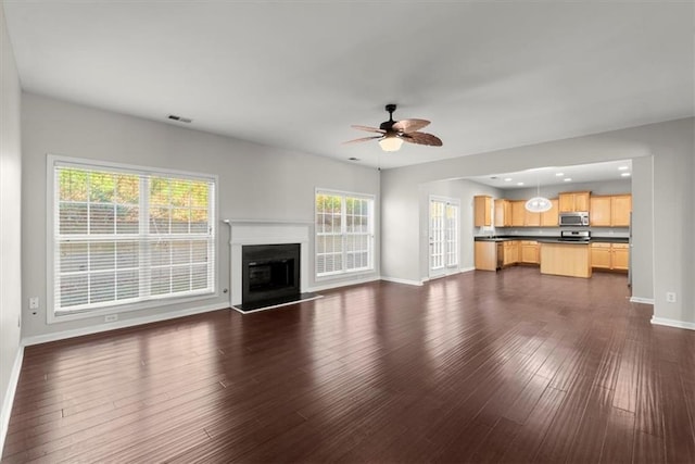 911 Queensbrooke Way, Mableton, GA 30126 - unfurnished living room featuring baseboards, ceiling fan, dark wood-style floors, and a fireplace