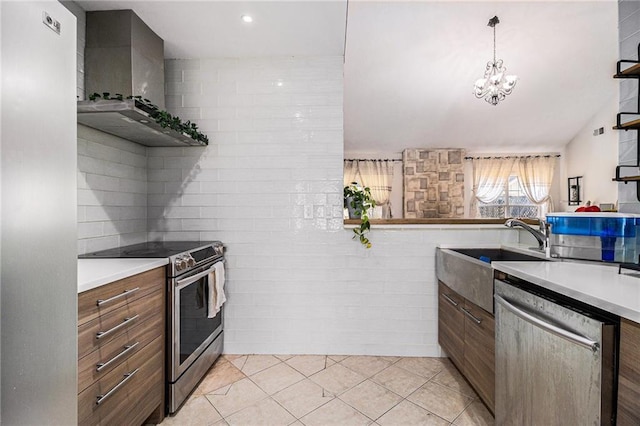 kitchen with light tile patterned floors, wall chimney exhaust hood, stainless steel appliances, light countertops, and a sink