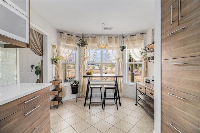 interior space featuring visible vents, baseboards, and light tile patterned floors