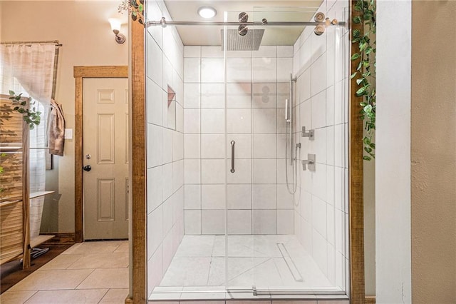 bathroom with tile patterned flooring and a shower stall