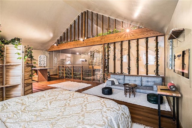 bedroom featuring high vaulted ceiling and wood finished floors