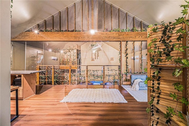 interior space with lofted ceiling and wood finished floors