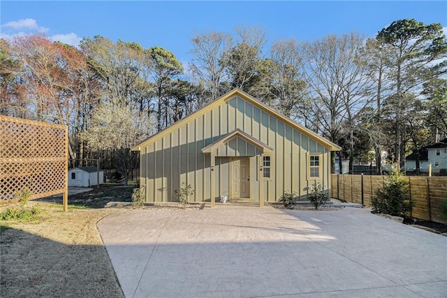 view of shed featuring fence