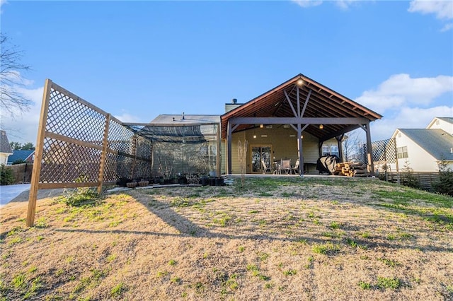 back of property featuring a patio area and fence