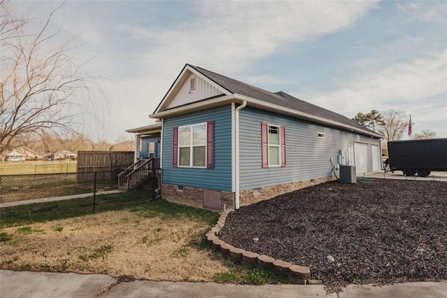 view of side of home featuring central AC and a yard