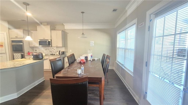 dining room with dark hardwood / wood-style floors and ornamental molding