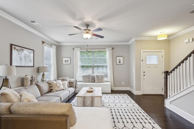 living area featuring crown molding and a healthy amount of sunlight