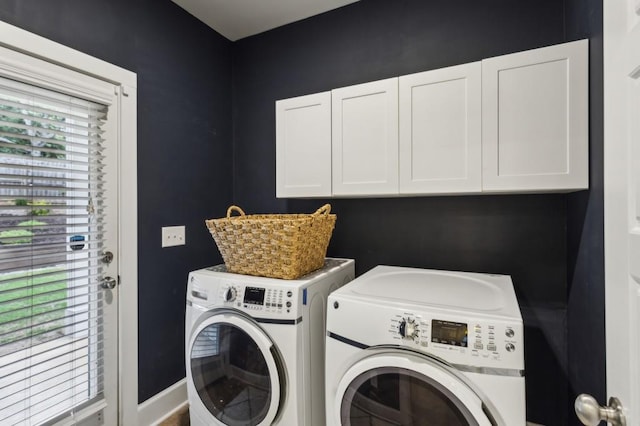 laundry area with cabinet space and independent washer and dryer
